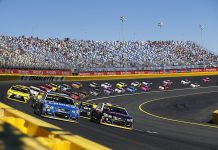 NASCAR settles charter lawsuit with Michael Jordan-backed 23XI Racing and Front Row Motorsports Nascar race taking place with cars on the bend in the track