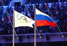 CAS imposes Tokyo Olympics and 2022 World Cup ban on Russia A Russian flag alongside the Olympic flag