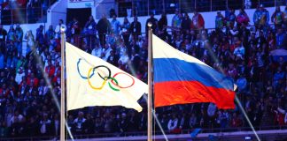 CAS imposes Tokyo Olympics and 2022 World Cup ban on Russia A Russian flag alongside the Olympic flag