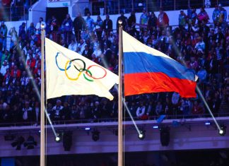CAS imposes Tokyo Olympics and 2022 World Cup ban on Russia A Russian flag alongside the Olympic flag