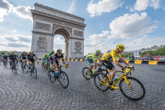 Cyclist Chris Froome passes by the Arc de Triomphe during Tour de France