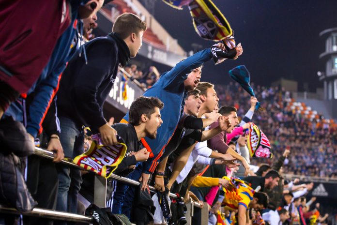 Valencia CF supporters celebrate at a La Liga match between Valencia and Real Madrid