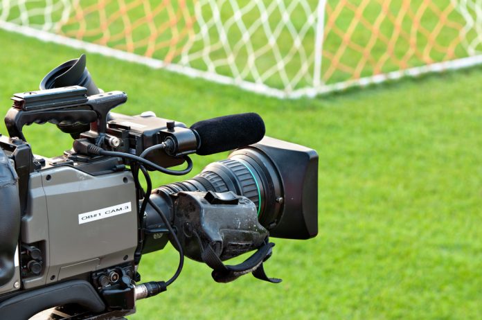 Television camera at the side of a football pitch