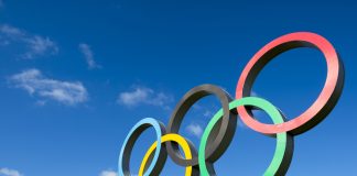 IOC approves new Olympic Agenda for upcoming Games RIO DE JANEIRO - MARCH 18, 2016: A large set of Olympic rings shines in bright sunlight against blue sky.