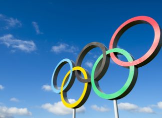IOC approves new Olympic Agenda for upcoming Games RIO DE JANEIRO - MARCH 18, 2016: A large set of Olympic rings shines in bright sunlight against blue sky.