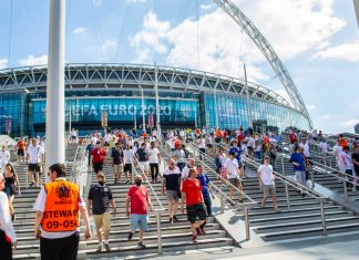 Betting ads cut by 47% during Euro 2020 from 2018 World Cup Fans walking outside of Wembley Stadium.
