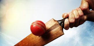 MLC hits for six securing Cognizant as title sponsor Cricket batsman hitting a ball shot from below against a blue sky.
