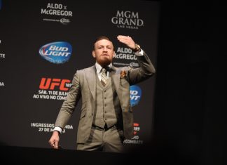 McGregor touches gloves with Tiger.Trade as its new ambassador