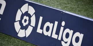 DAZN nets LaLiga Italy and Portugal renewal and raises UK fees La Liga logo on a sign on a football pitch.