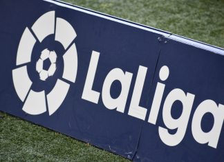 La Liga breaks revenue records with €5bn for 2023/24 season La Liga logo on a sign on a football pitch.