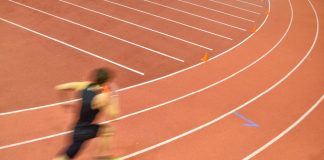 Michael Johnson’s track league partners with industry leaders Man running round track.