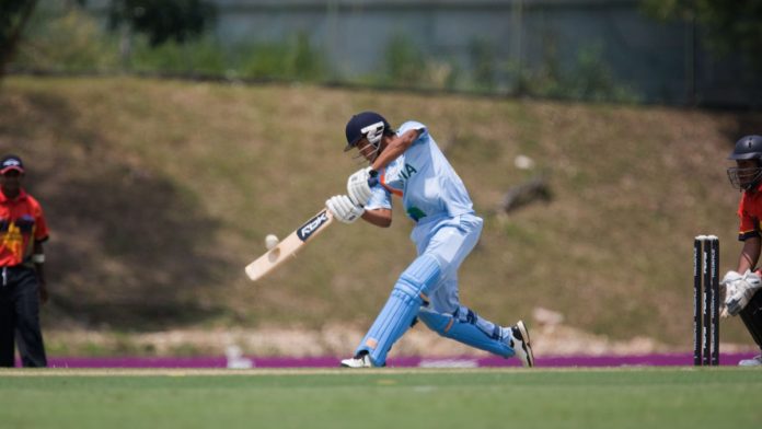 Cricket player hitting ball