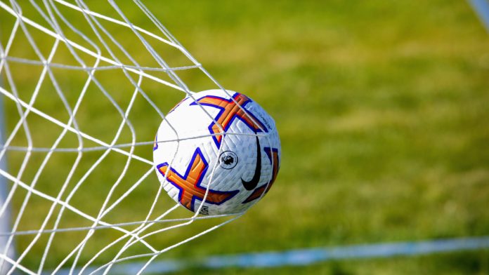 Ball hitting the back of a football net.