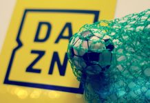 DAZN signs exclusive National League rights in domestic English football debut A yellow DAZN sign next to a football in a green net.