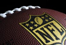 Sportsbreak.com renews NFL partnership amid popularity surge Black NFL ball with gold accents.