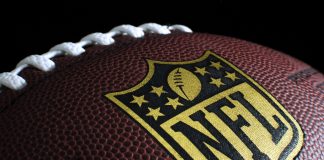 Sportsbreak.com renews NFL partnership amid popularity surge Black NFL ball with gold accents.