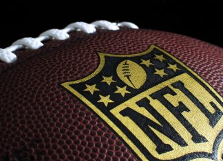 Amazon’s NFL Wild Card deal extended for seven more years Black NFL ball with gold accents.