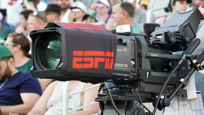 Broadcast camera at a sports match with ESPN branding.