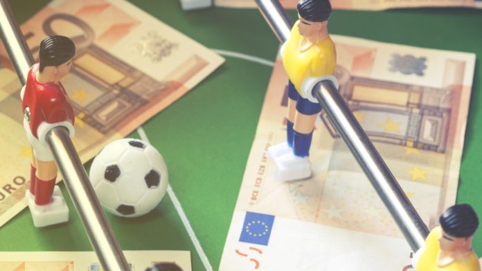 Euro notes on a foosball table.