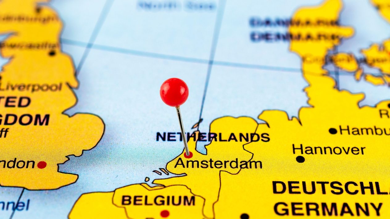 Image of a map with a pin stuck in the Netherlands