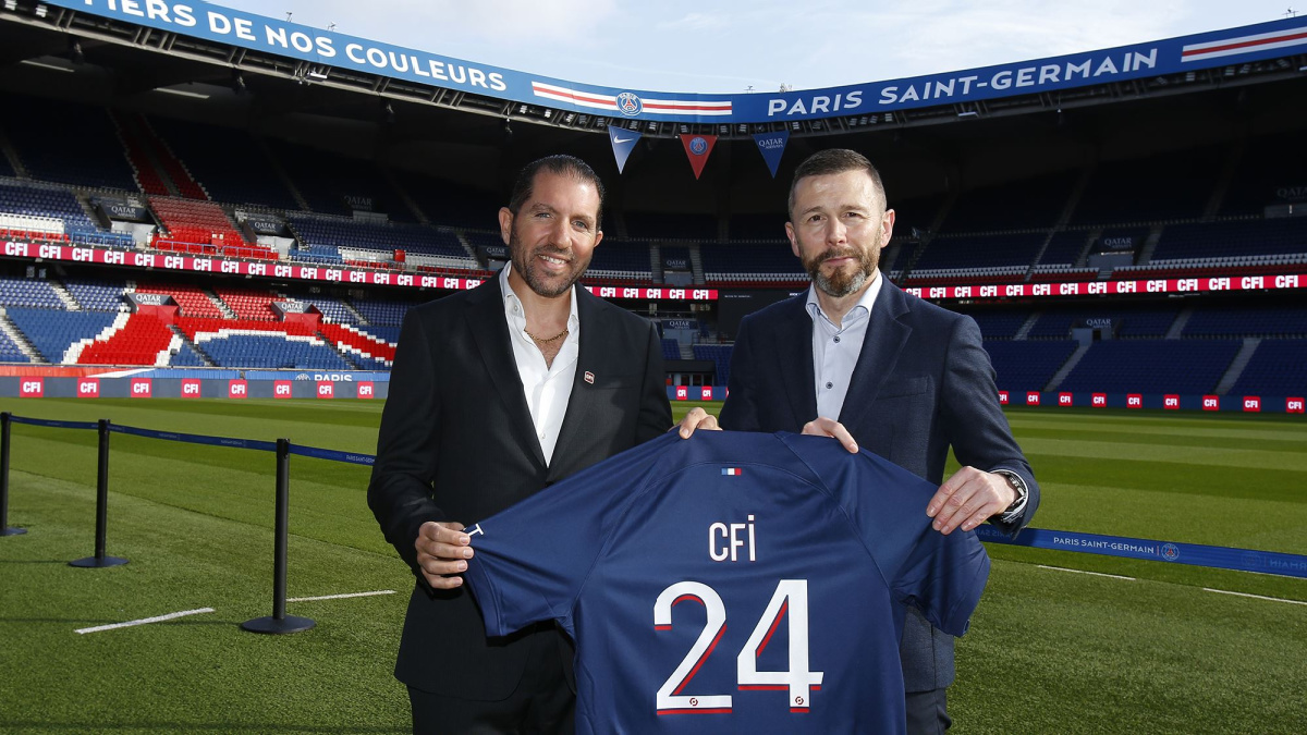 PSG and CFI holding up a football shirt to signify their new deal.