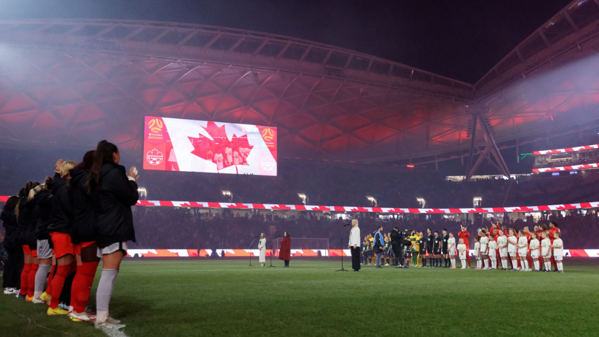 Players in a line before playing in an international football game for Canada.