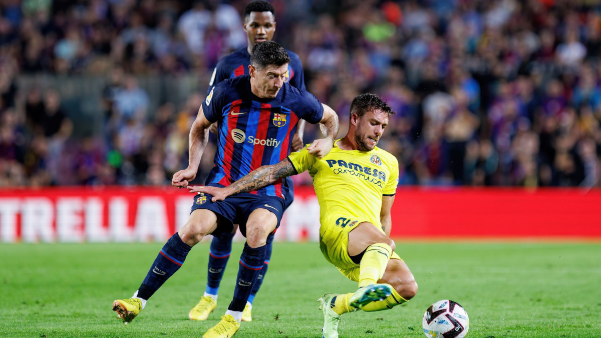 Two La Liga football players battling for the ball.