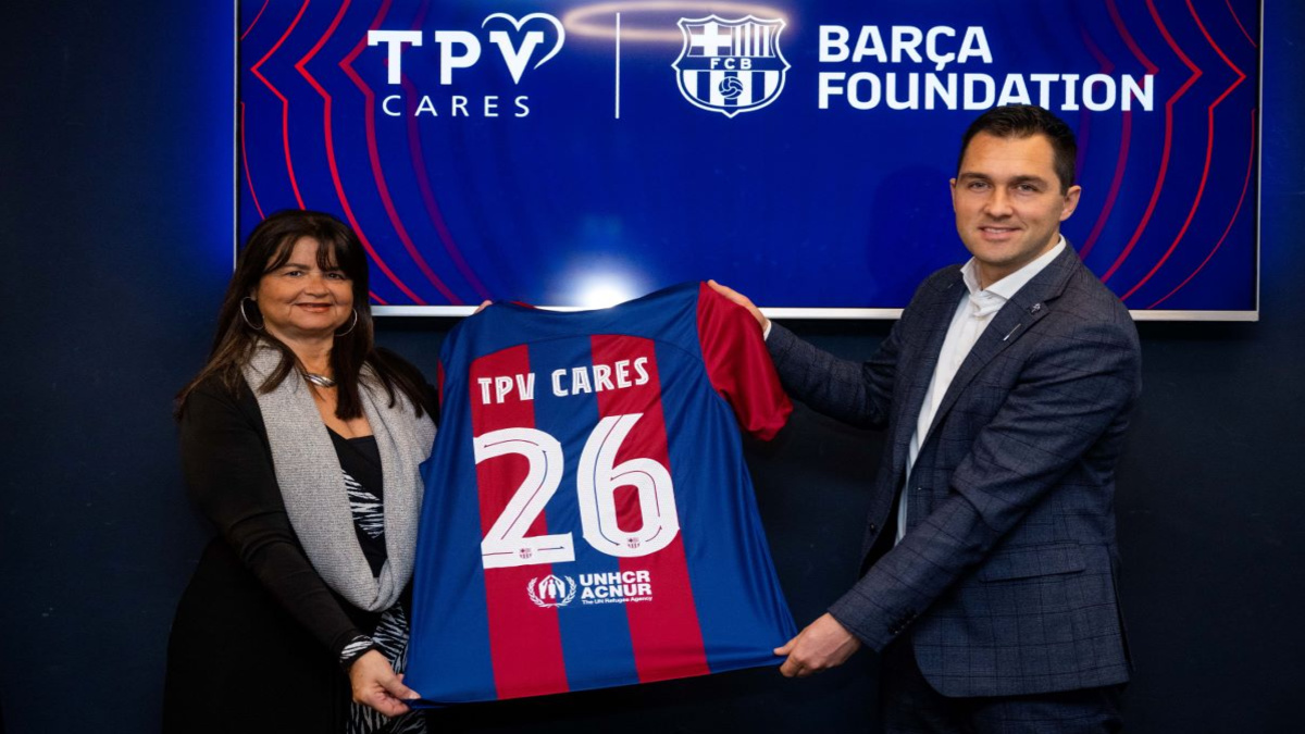 TPV Cares and Barca Foundation holding up FC Barcelona kit to signify the new partnership.