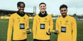 Borussia Dortmund scores with PRIME Hydration partnership Three BVB players posing with yellow PRIME drinks on a football pitch.