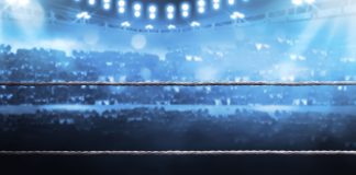 DAZN set to host ‘Knockout Chaos’ live worldwide Boxing arena with blurred spectator and stadium light