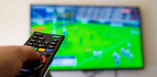 World Rugby and CBS Sports agree broadcast deal through 2029 Close up shot of man watching a rugby game.