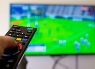 World Rugby and CBS Sports agree broadcast deal through 2029 Close up shot of man watching a rugby game.