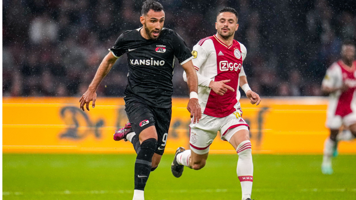 Two Dutch Eredivisie player's playing football.