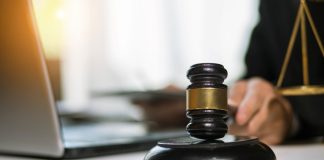 NCAA faces upheaval as court clears athletes for NIL deals Male judge banging hammer.