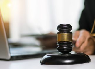 NCAA faces upheaval as court clears athletes for NIL deals Male judge banging hammer.
