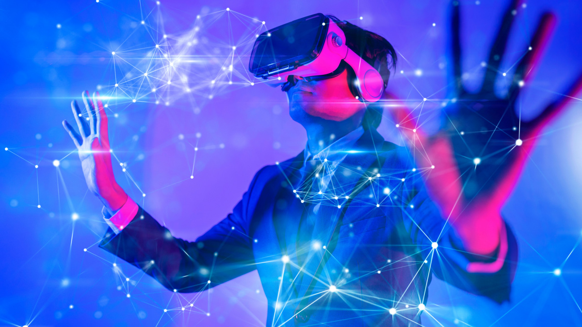 Man in VR headset touching a digital barrier.