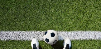 Manchester United plans to explore AR via player cameras A football at a player's feet from the player's perspective.
