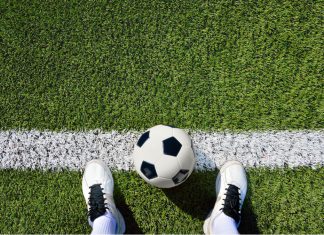 Manchester United plans to explore AR via player cameras A football at a player's feet from the player's perspective.