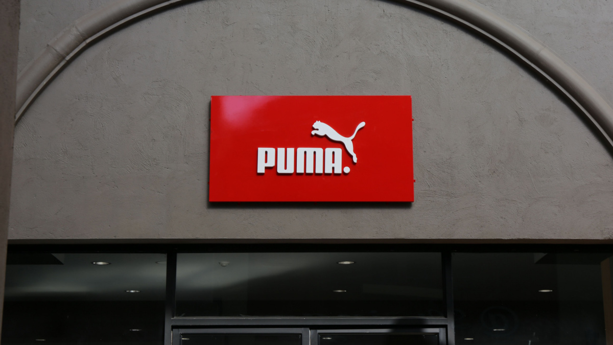 A red Puma sign on the front of a shop.