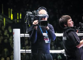 Boxxer brings its events to Sub-Saharan Africa with new deal Man holding camera in boxing ring.