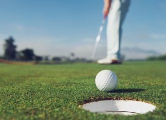 New Zealand Open tees up excitement with TAB partnership Man putting a golf ball into the hole.