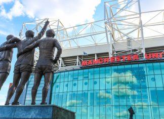 Manchester United & Stone Roses fuses fashion with football The trinity statue outside of Old Trafford.