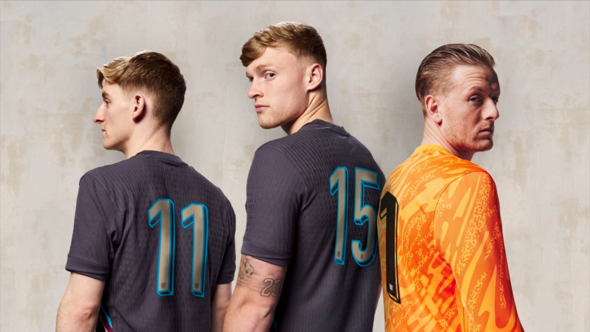 Three England players stood showing nameless kits.