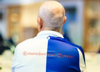 Blackburn Rovers receives grant to fuel Alzheimer’s support Man satdown with 'Remember The Rovers' written on the back of his football kit.