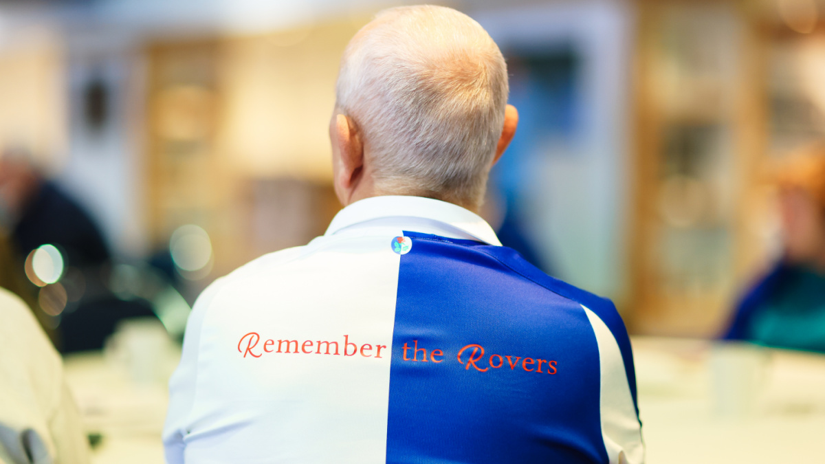 Man satdown with 'Remember The Rovers' written on the back of his football kit.