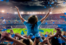 Atos ventures into Saudi Arabia with MENA HQ Woman standing in stadium with crowd behind her.