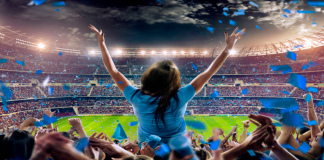 Atos ventures into Saudi Arabia with MENA HQ Woman standing in stadium with crowd behind her.
