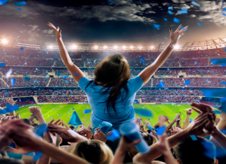 Atos ventures into Saudi Arabia with MENA HQ Woman standing in stadium with crowd behind her.