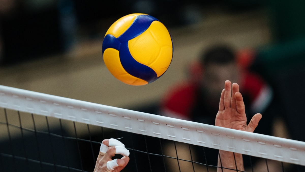 Volleyball action. Ball above net during volleyball game.