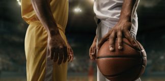 Roku & NBA launches ‘tailored to the fan’ streaming channel Two basketball players on big professional arena before the game.